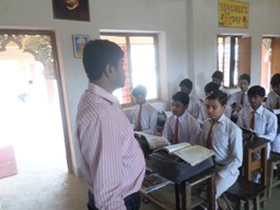 Teacher guiding students in a classroom